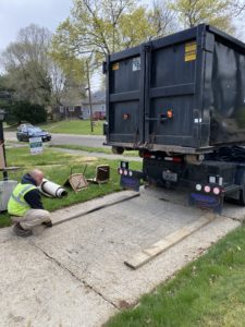 Trash Daddy Dumpster Backing into A Residential Driveway