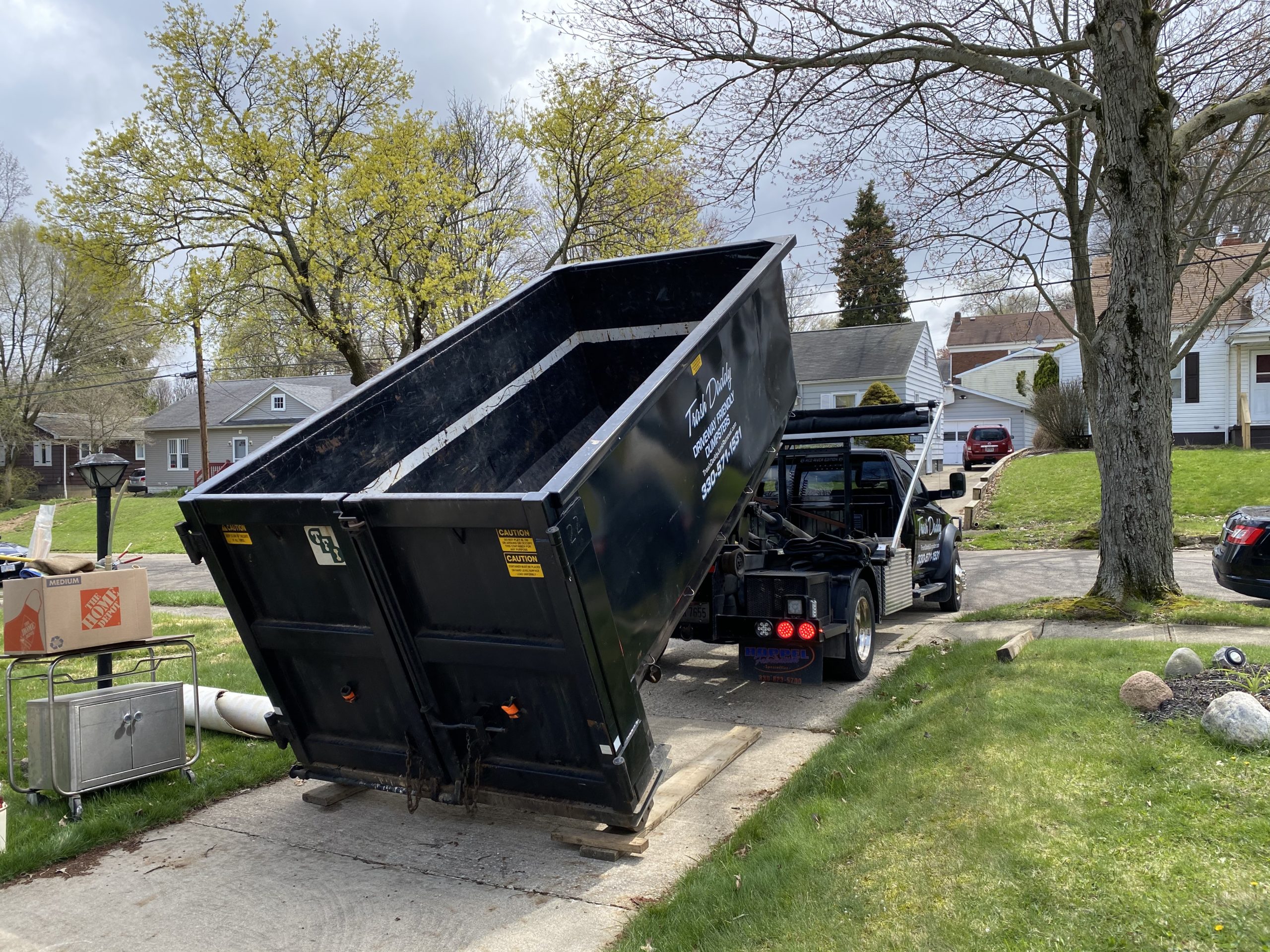 Driveway Friendly Dumpster Being Placed on Planks